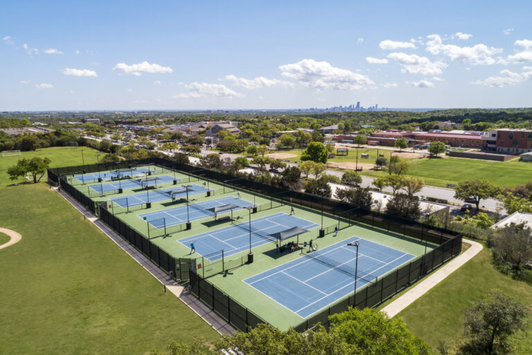 Dell Jewish Community Center Expansion designed by Beck Architecture
Beck provided master planning, architecture, and interior design for the Dell Jewish Community Center. The project spanned multiple phases and included the renovation and expansion of multiple existing buildings, along with the construction of new community, fitness, aquatics and tennis facilities.  Beck’s design focused on creating vibrant spaces that prioritized places for gathering, sustainability and resilience, while infusing meaning into the architecture itself, inspired by the rich cultural heritage of the Jewish people.
The final phase provided a 40,000 SF community and fitness building, which now serves as the main entry for the community center.  The design takes inspiration both from local design strategies and materiality, while infusing meaning from Jewish culture. The building includes a new coffee shop, multi-purpose meeting rooms, an upgraded fitness center, and Shalom Austin’s offices. This phase also included an aquatics expansion and a new tennis facility with a lap pool, play pool, water slides, and concessions building, as well as six outdoor tennis courts.

Beck’s work on the Dell Jewish Community Center is a testament to their expertise and dedication to excellence in architectural design and planning. The project’s impact will be felt for years to come, as the community benefits from the new and improved amenities.