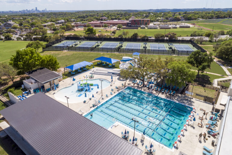 Dell Jewish Community Center Expansion designed by Beck Architecture
Beck provided master planning, architecture, and interior design for the Dell Jewish Community Center. The project spanned multiple phases and included the renovation and expansion of multiple existing buildings, along with the construction of new community, fitness, aquatics and tennis facilities.  Beck’s design focused on creating vibrant spaces that prioritized places for gathering, sustainability and resilience, while infusing meaning into the architecture itself, inspired by the rich cultural heritage of the Jewish people.
The final phase provided a 40,000 SF community and fitness building, which now serves as the main entry for the community center.  The design takes inspiration both from local design strategies and materiality, while infusing meaning from Jewish culture. The building includes a new coffee shop, multi-purpose meeting rooms, an upgraded fitness center, and Shalom Austin’s offices. This phase also included an aquatics expansion and a new tennis facility with a lap pool, play pool, water slides, and concessions building, as well as six outdoor tennis courts.

Beck’s work on the Dell Jewish Community Center is a testament to their expertise and dedication to excellence in architectural design and planning. The project’s impact will be felt for years to come, as the community benefits from the new and improved amenities.